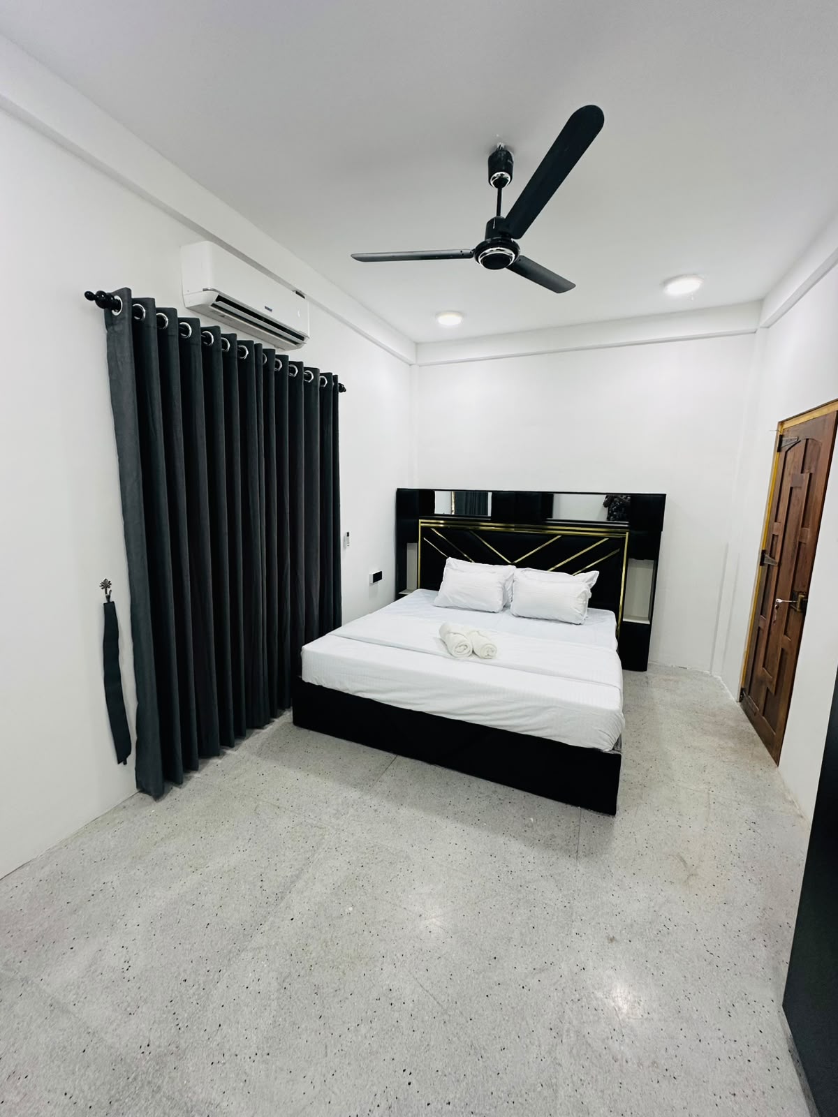Bedroom wide angle with vanity mirror and wood door finishes