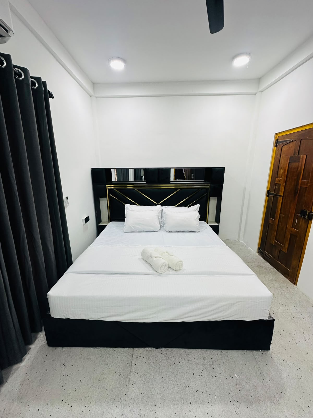 Bedroom with bed and curtains in a quiet neutral palette